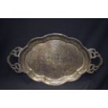 A 19TH CENTURY EASTERN BRASS TRAY, engraved with foliage. 52 cm wide.