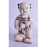 AN UNUSUAL EARLY CHINESE CHIZOU POTTERY FIGURE OF A BOY pained with motifs. 22.5 cm high.