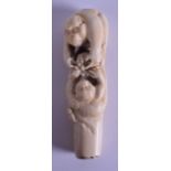 A 19TH CENTURY JAPANESE MEIJI PERIOD CARVED IVORY PARASOL HANDLE in the form of two clambering