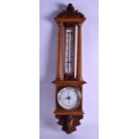 A LATE VICTORIAN/EDWARDIAN OAK ANEROID BAROMETER. 75 cm long.