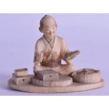 A LATE 19TH CENTURY JAPANESE MEIJI PERIOD CARVED IVORY OKIMONO modelled as a seated artisan. 7 cm