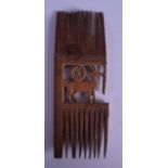 AN EARLY EGYPTIAN CARVED WOODEN COMB formed with a stylised animal. 13.5 cm long.