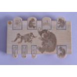 A 19TH CENTURY JAPANESE MEIJI PERIOD CARVED IVORY WHIST MARKER engraved with monkeys and vegetables.