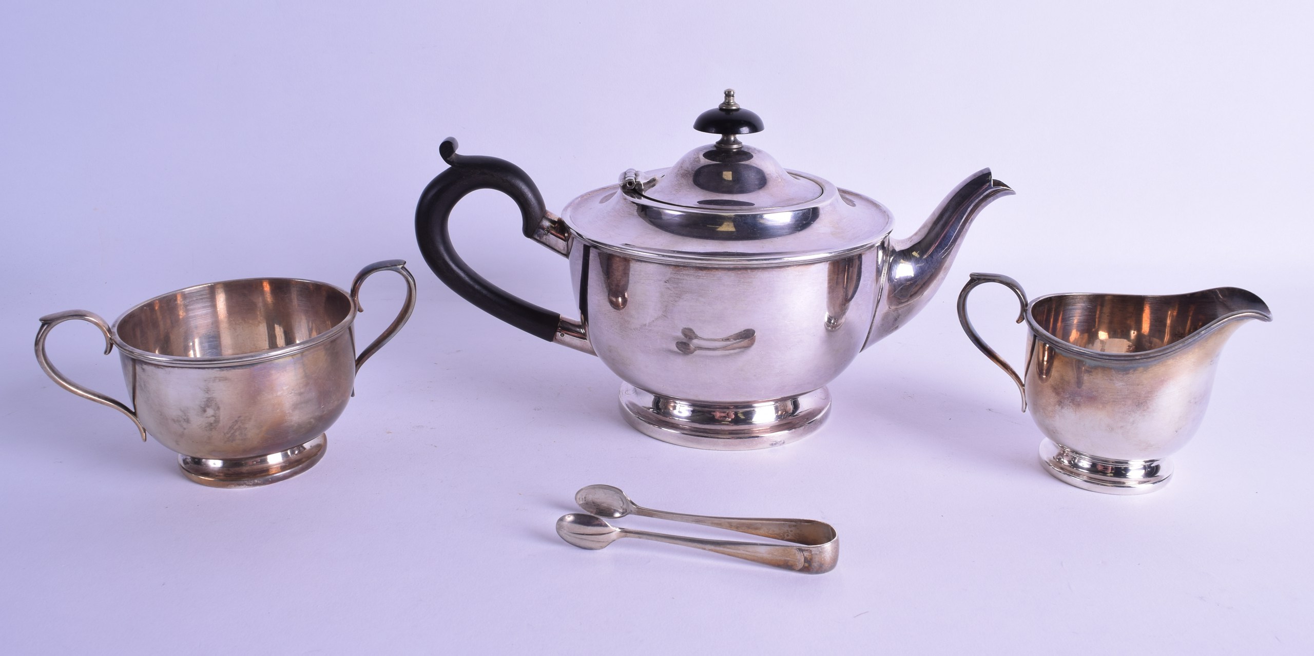 A SILVER PLATED THREE PIECE SILVER PLATED TEA SET by Harrods of London, together with a pair of - Image 2 of 3