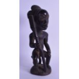AN AFRICAN CARVED TRIBAL WOOD FIGURE depicting a seated male holding a staff. 28.5 cm high.