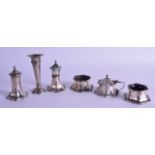 A PAIR OF SILVER PEPPER POTS together with a pair of silver salts, a silver mustard pot & silver