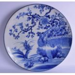 A VERY LARGE 19TH CENTURY JAPANESE MEIJI PERIOD BLUE AND WHITE CHARGER painted with a bird upon