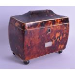 AN EARLY 19TH CENTURY TORTOISESHELL AND IVORY TEA CADDY AND COVER with silver inlay to the top,