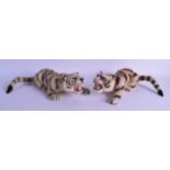 AN UNUSUAL PAIR OF MID 20TH CENTURY TAXIDERMY STYLE MINIATURE TIGERS. 27 cm long.