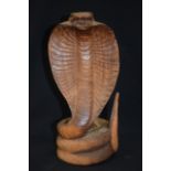 A CARVED HARDWOOD GROUP, formed as a cobra. 32 cm high.