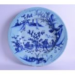 A LARGE EARLY 18TH CENTURY DELFT BLUE AND WHITE CIRCULAR DISH painted with Oriental figures within