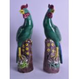 A PAIR OF EARLY 20TH CENTURY CHINESE EXPORT FIGURES OF HENS overlaid with foliage and vines. 31.5 cm