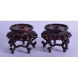 A STYLISH PAIR OF EARLY 20TH CENTURY CHINESE HARDWOOD VASE STANDS of naturalistic form. Overall 10