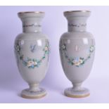 A PAIR OF LATE VICTORIAN/EDWARDIAN GREEN VASES enamelled with butterflies and foliage. 27 cm high.