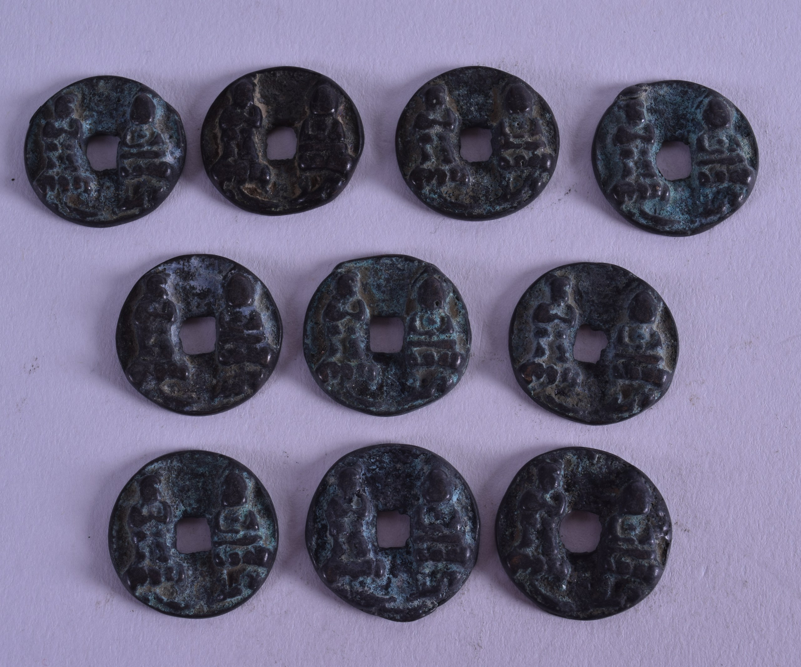 A GROUP OF TEN CHINESE COINS. 2 cm diameter. (10)