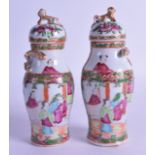 A SMALL PAIR OF 19TH CENTURY CHINESE CANTON FAMILLE ROSE BALUSTER VASES AND COVERS painted with
