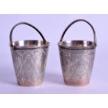 A PAIR OF 19TH CENTURY IRANIAN SILVER SWING HANDLED BASKETS engraved with flowers and motifs. 4.5