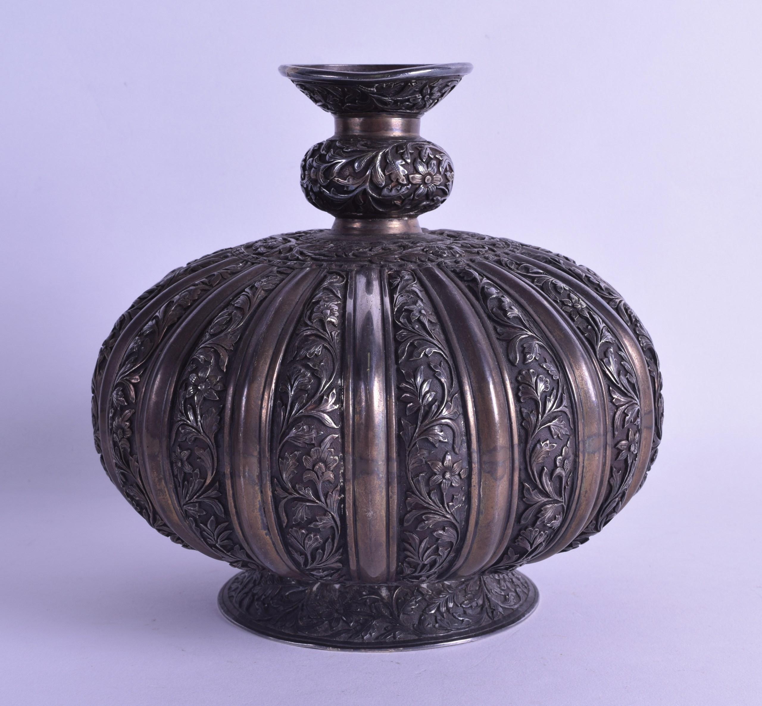 A FINE 18TH/19TH CENTURY PERSIAN/OTTOMAN BULBOUS SILVER VASE decorated in relief with scrolling