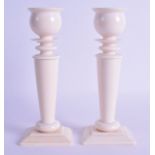 A GOOD PAIR OF 19TH CENTURY EUROPEAN CARVED IVORY CANDLESTICKS of classical form upon rectangular