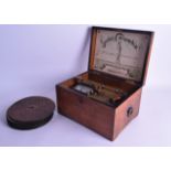 AN EARLY 20TH CENTURY GERMAN WIND UP MUSICAL BOX with numerous discs, the label titled ~Spieldose