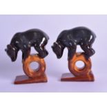 A PAIR OF RUSSIAN USSR POTTERY FIGURES OF BEARS modelled performing an act of balance. 16.5 cm