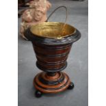 A WOODEN BUCKET, with brass liner. 42 cm high