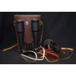 A LARGE PAIR OF BINOCULARS, together with a smaller cased pair. (2)