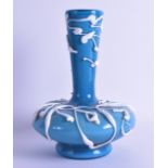 AN UNUSUAL ITALIAN WHITE ENAMEL OVERLAID BLUE GLASS VASE. 25 cm high.