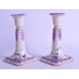 AN UNUSUAL PAIR OF EARLY 20TH CENTURY ENGLISH PORCELAIN CANDLESTICKS possibly painted by a Worcester