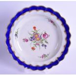 18th c. Worcester scalloped plate painted with flowers under an unusual light blue border with