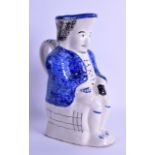 A 19TH CENTURY FRENCH SPONGE DECORATED FAIENCE TOBY JUG in the form of a seated male. 24.5 cm