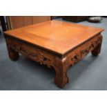 AN EARLY 20TH CENTURY CHINESE CARVED SOFTWOOD LOW TABLE with carved frieze. 80 cm square x 32 cm.