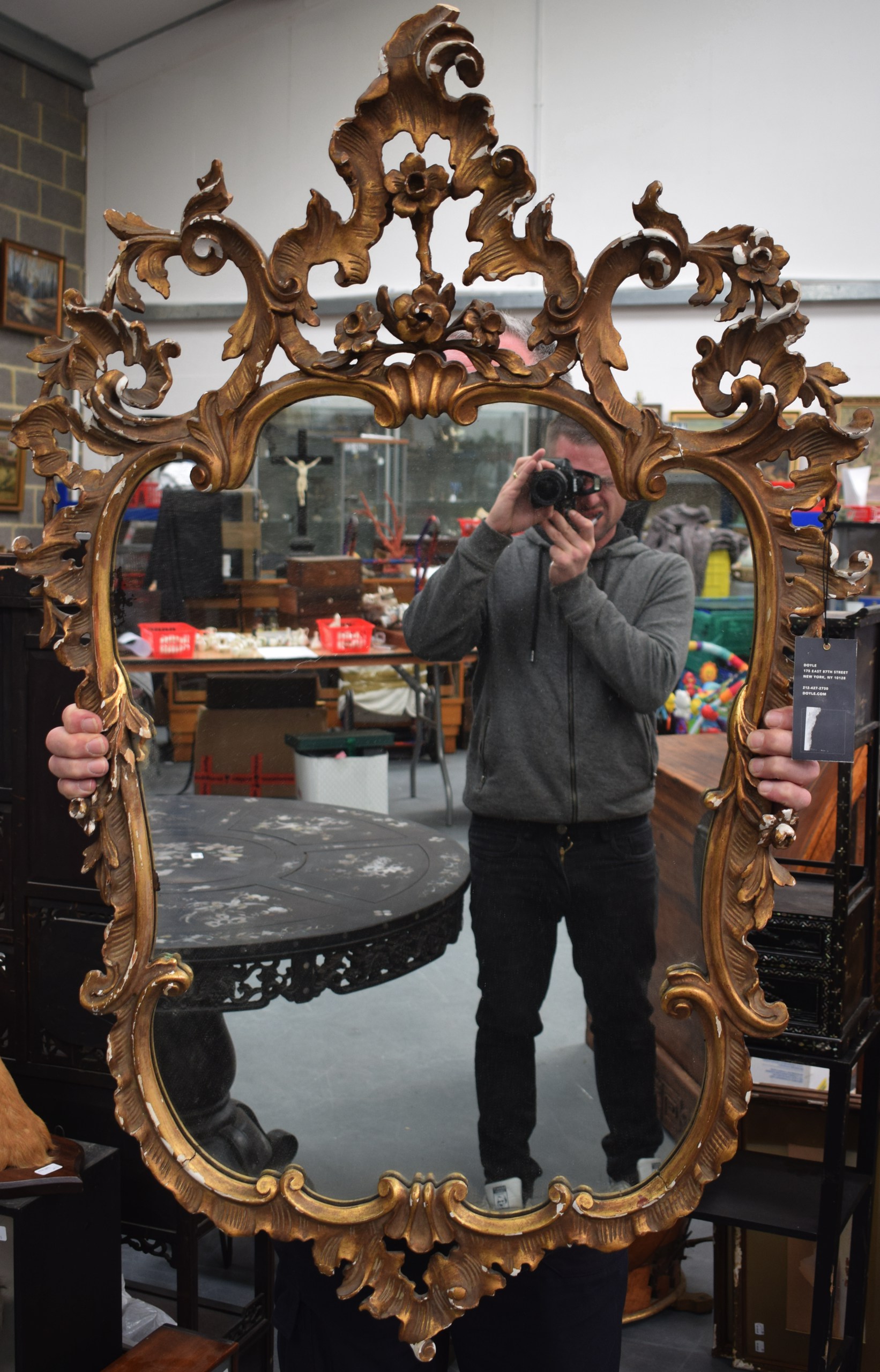 A SCROLLING GILTWOOD MIRROR Louis XV style. 76 cm x 126 cm. A/F