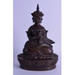 A LARGE 18TH/19TH CENTURY TIBETAN BRONZE FIGURE OF A SEATED MALE modelled with hands crossed, upon a