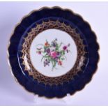 18th c. Worcester scalloped plate painted with flowers under an elaborate gold inner border and a