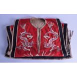 AN EARLY 20TH CENTURY CHINESE RED SILKWORK EMBROIDERED JACKET decorated with dragons and birds. 90