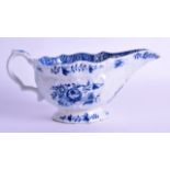 18th c. Bow blue and white sauceboat painted with flowers on a moulded body. 20cm wide. Heavily