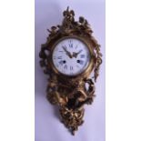 A MID 19TH CENTURY FRENCH GILT BRONZE CARTEL CLOCK with white enamel dial, the case mounted with