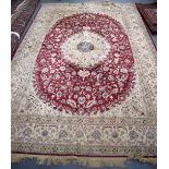 A GOOD LARGE PERSIAN BEIGE GROUND RUG, extensively decorated with flowers and foliage. 290 cm x