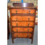 A CARVED OAK CHEST ON STAND, with burr walnut drawers.