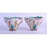 A PAIR OF EARLY 20TH CENTURY CHINESE FAMILLE ROSE LIBATION CUPS in the form of open lotus flowers.