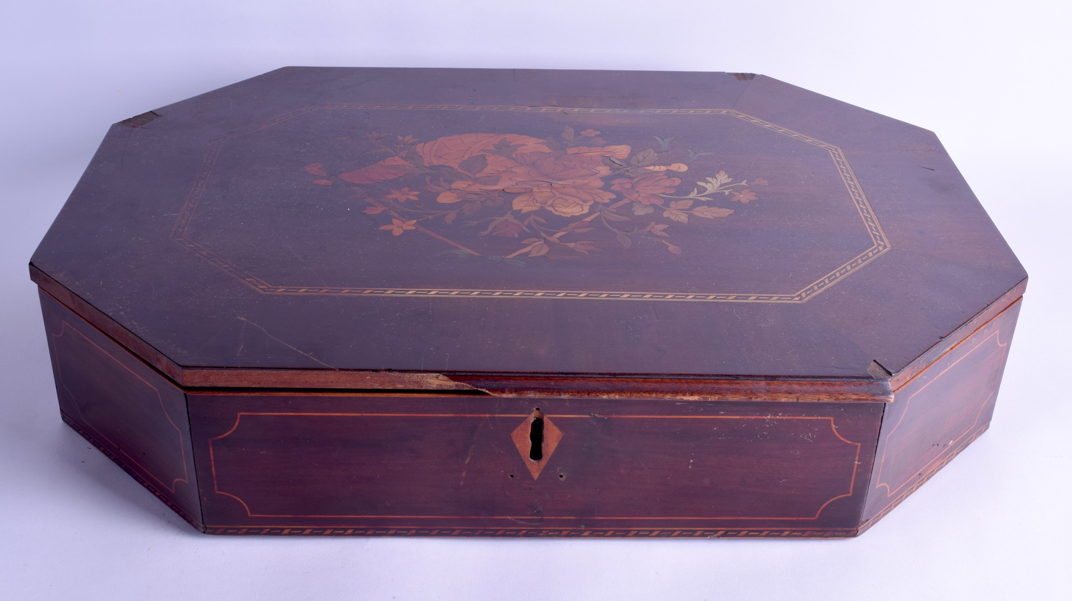 AN EARLY 19TH CENTURY CONTINENTAL CARVED WOOD OCTAGONAL CASKET decorated with a cornucopia of