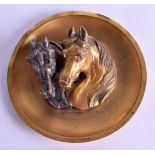 A LATE VICTORIAN/EDWARDIAN BRONZE AND BRASS DISH depicting two horses in relief. 13.5 cm diameter.