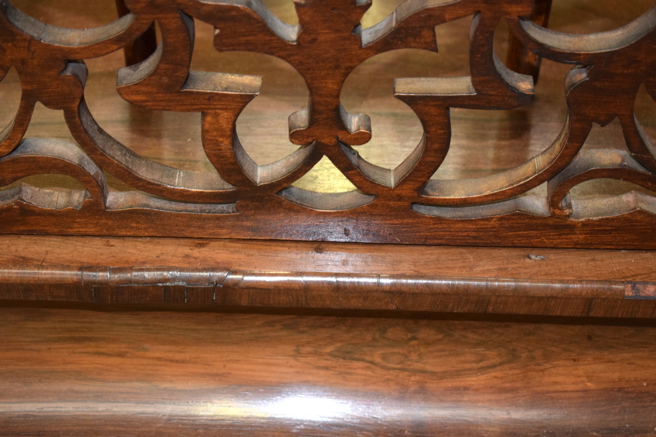 A VICTORIAN FIGURED WALNUT CANTERBURY, with carved fretwork and turned upright supports. 64 cm - Image 3 of 3