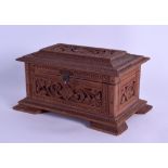 A LATE 19TH CENTURY INDIAN CARVED HARDWOOD CASKET AND COVER possibly Sandalwood, decorated with a