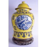 A LARGE CHINESE BLUE AND WHITE GINGER JAR AND COVER painted with panels upon a yellow ground. 55