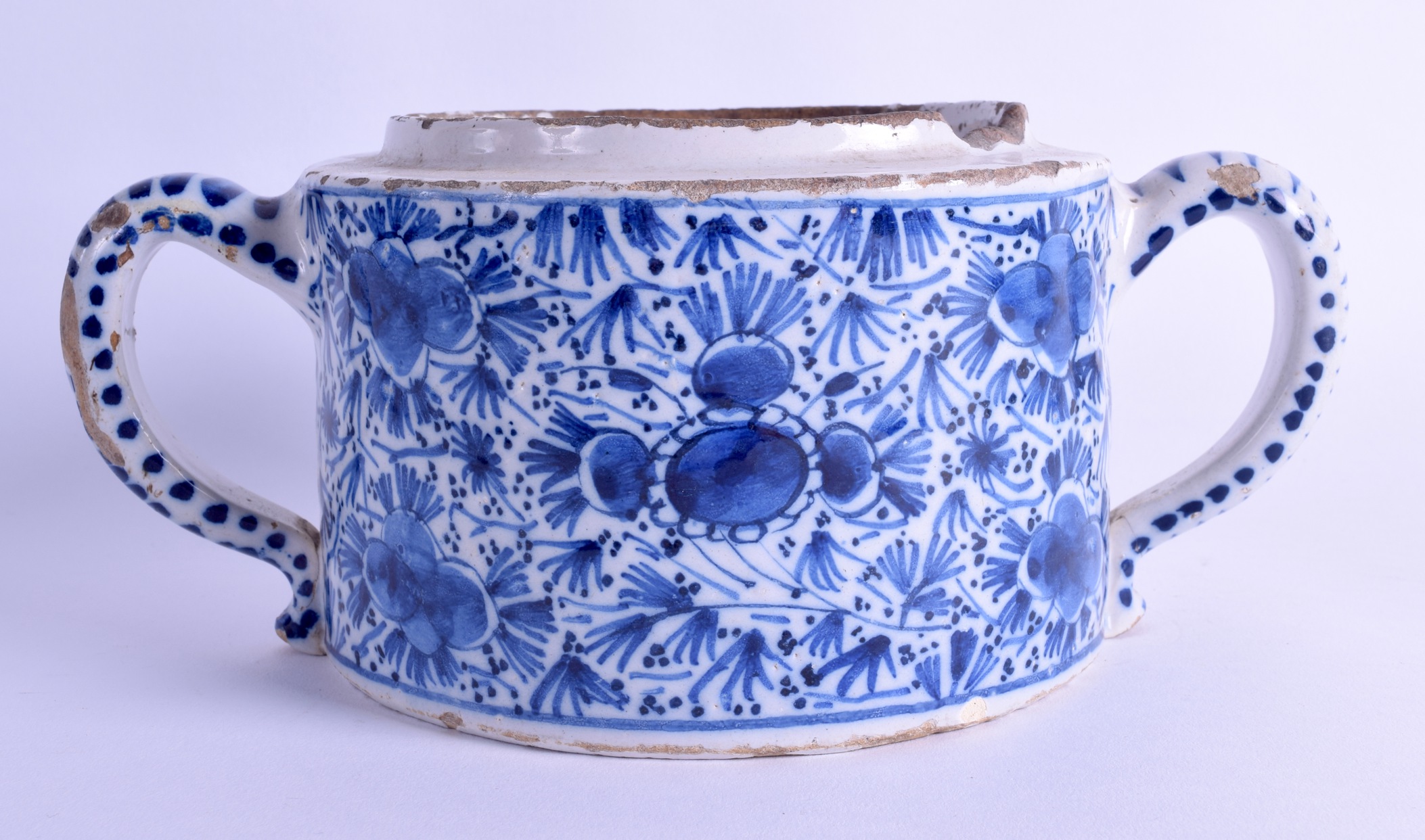 AN 18TH CENTURY TWIN HANDLED DELFT POSSET POT painted with floral sprays and vines. 23 cm wide.