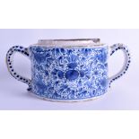 AN 18TH CENTURY TWIN HANDLED DELFT POSSET POT painted with floral sprays and vines. 23 cm wide.