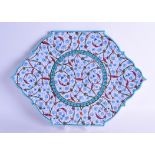 AN IZNIK POTTERY DISH by Saim Kolhan, painted with scrolling sprays. 37 cm wide.