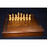 A VINTAGE BOXED CHESS SET, the ineterior with fitted section for each piece. king height 6 cm.